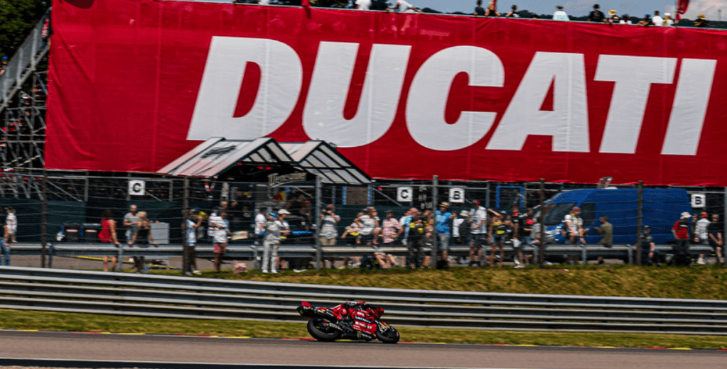 Francesco Bagnaia rides under a Ducati banner during a MotoGP session