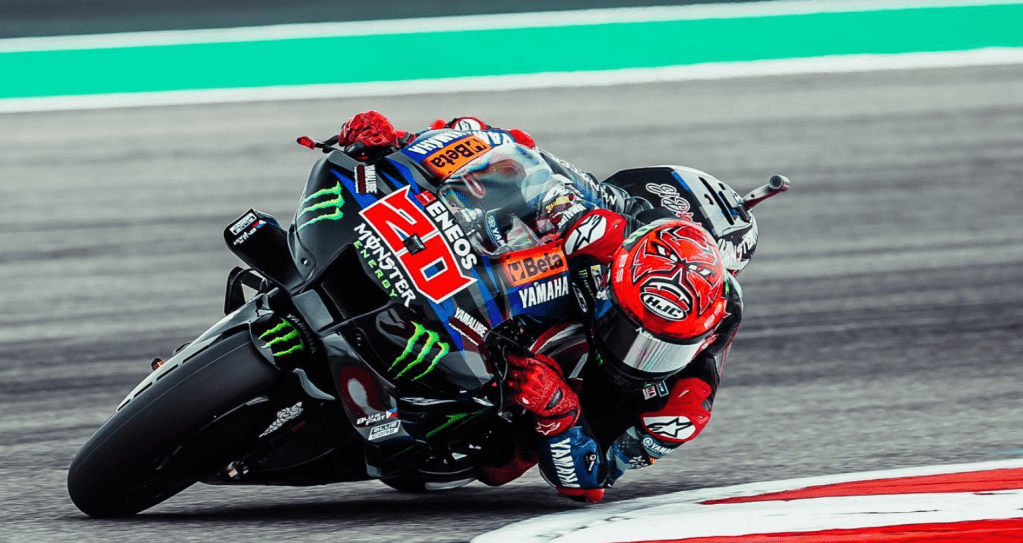 Fabio can be seen on a blue bike with the monster logo, and a red number 20. Also wearing a red devil helmet and red boots, with the slogan El Diablo on his back.