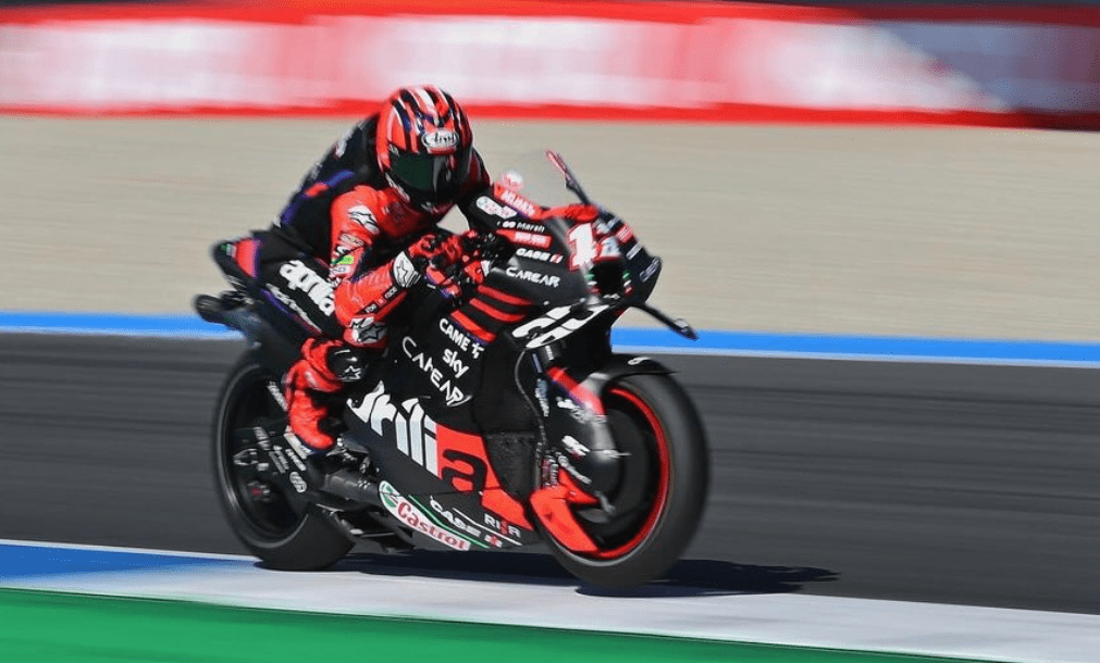 Maverick rides the black and red Aprilia, and wears matching black leather with red arms. His silver number 12 is on the front, and he can be distinguished from his teammate by his red helmet and boots.