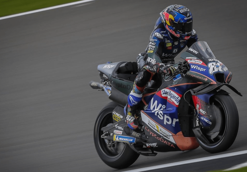 Miguel can be spotted on a dark blue and forest green bike with orange highlights, a white 88 on the front, and a red bull sponsored helmet.